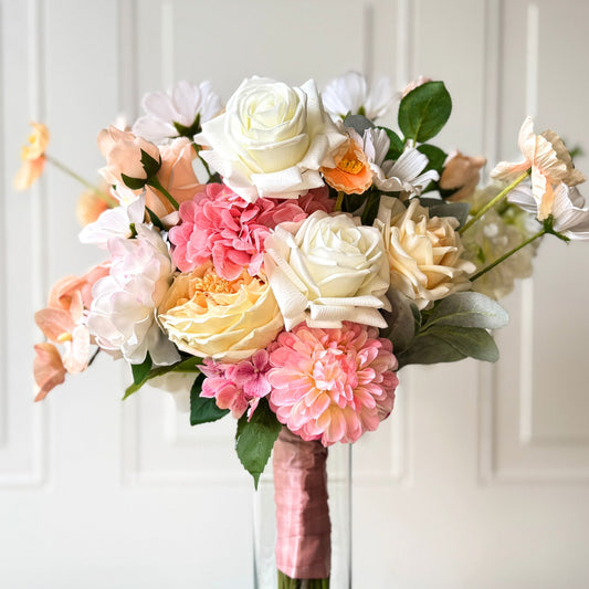 Realistic artificial flower bridal bouquet featuring white artificial roses, blush artificial peonies, apricot artificial tulips, cream artificial tea roses, pink artificial hydrangeas, and white artificial cosmos — Real Touch flowers from My Faux Florist Canada.