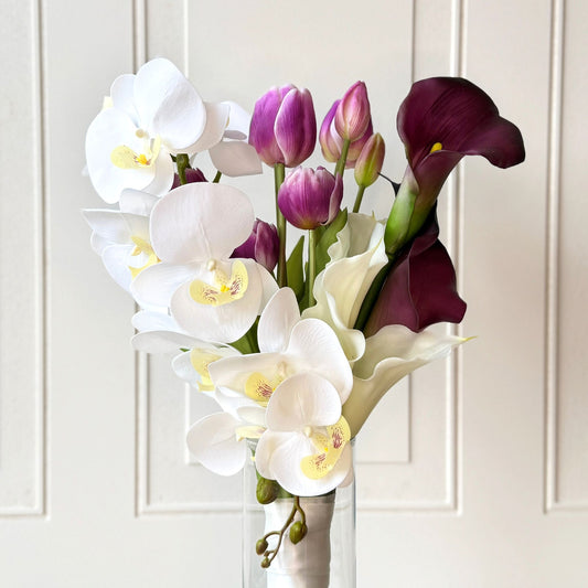 Artificial flower bridal bouquet featuring white artificial orchids, deep wine artificial calla lilies, white artificial calla lilies, and lavender artificial tulips — from My Faux Florist Canada.