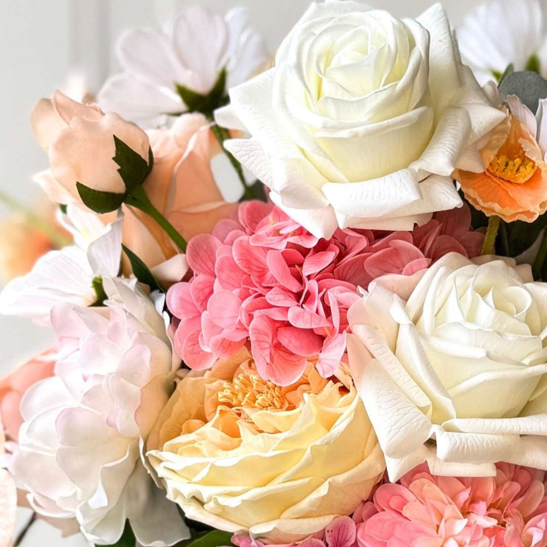 Realistic artificial flower bridal bouquet featuring white artificial roses, blush artificial peonies, apricot artificial tulips, cream artificial tea roses, pink artificial hydrangeas, and white artificial cosmos — Real Touch flowers from My Faux Florist Canada.
