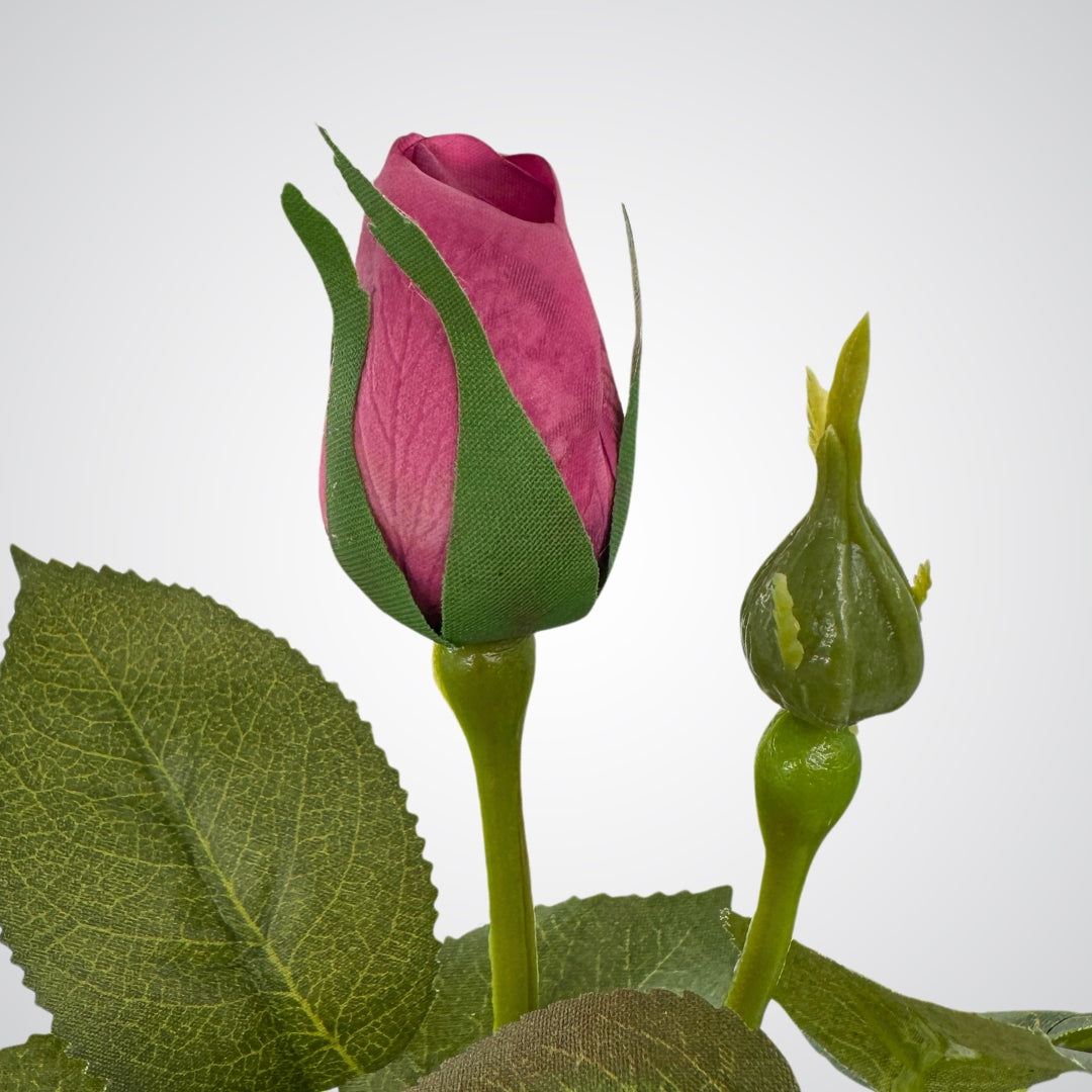 close up of burgundy realistic artificial rose bud and green leaves by My Faux Florist Canada