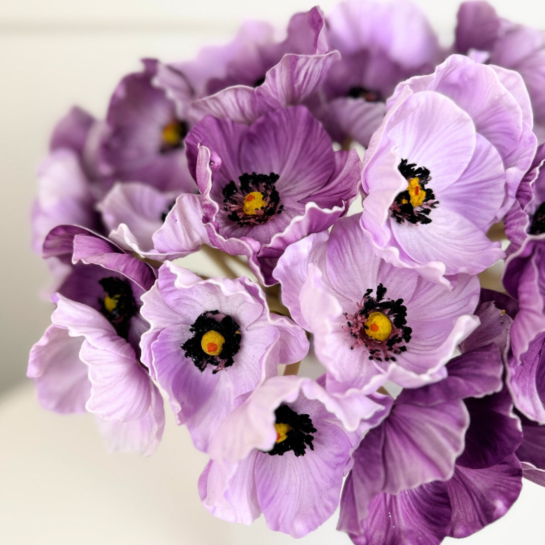 Close-up of purple artificial poppies with yellow centers, in a vase, from My Faux Florist Canada