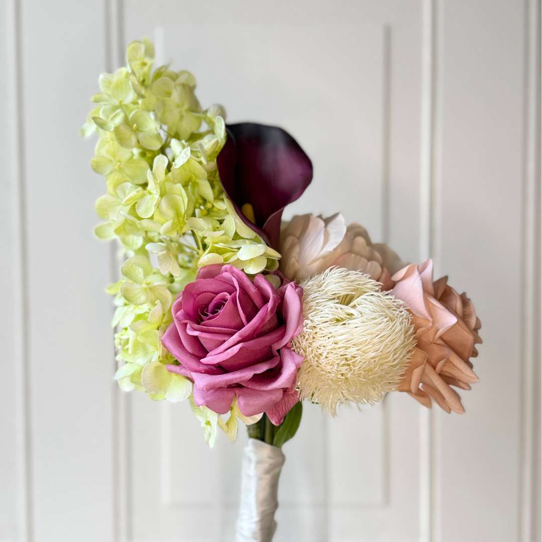 Realistic artificial flower bouquet featuring pale green artificial hydrangeas, mauve artificial roses, blush artificial peonies, white artificial allium, and deep wine artificial calla lilies — from My Faux Florist Canada.
