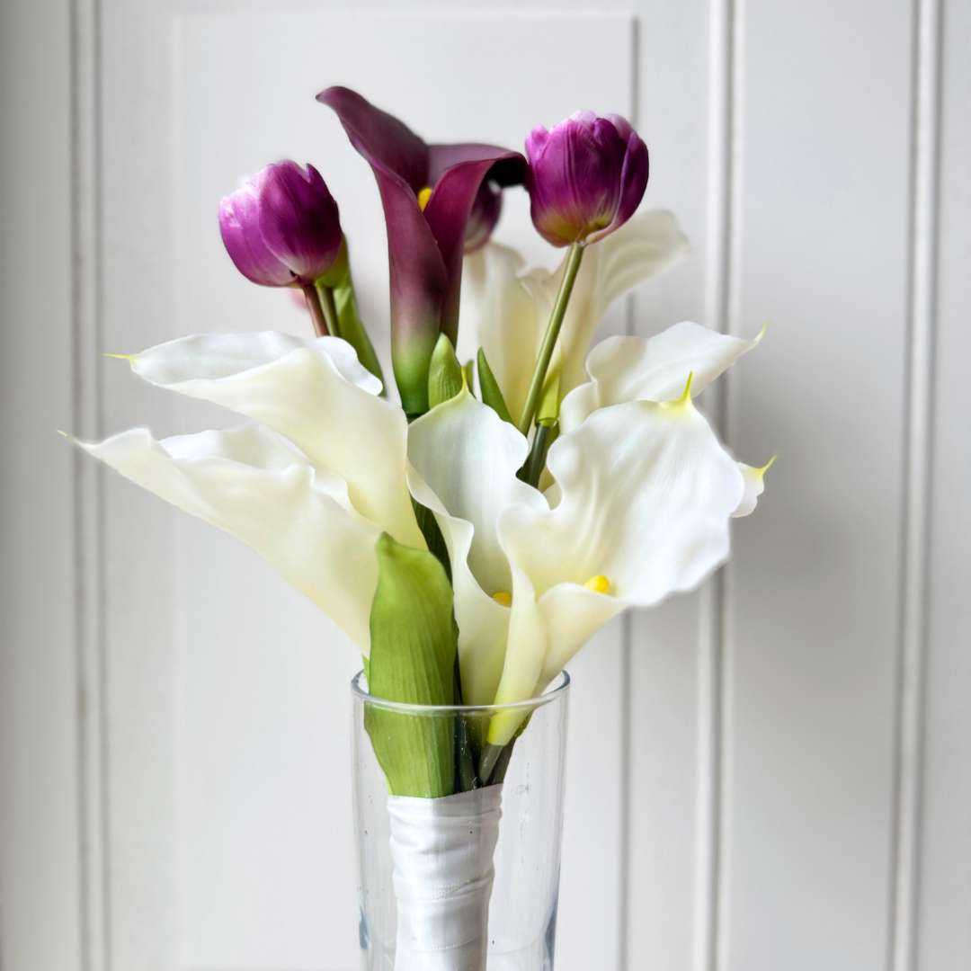 Realistic artificial flower bridal bouquet featuring white artificial orchids, deep wine artificial calla lilies, white artificial calla lilies, and lavender artificial tulips — from My Faux Florist Canada.