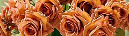 Close-up of realistic artificial roses in rich copper and apricot tones, showcasing layered petals and natural texture — real touch roses from My Faux Florist Canada.