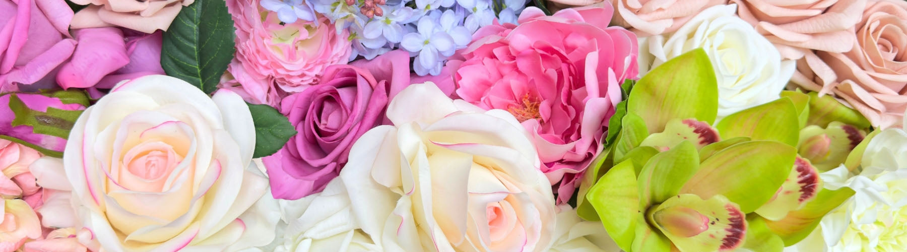 Close-up of various fake flowers including faux roses and faux orchids and fake peonies with a soft focus effect and Real Touch flowers by My Faux Florist artificial flowers Canada.