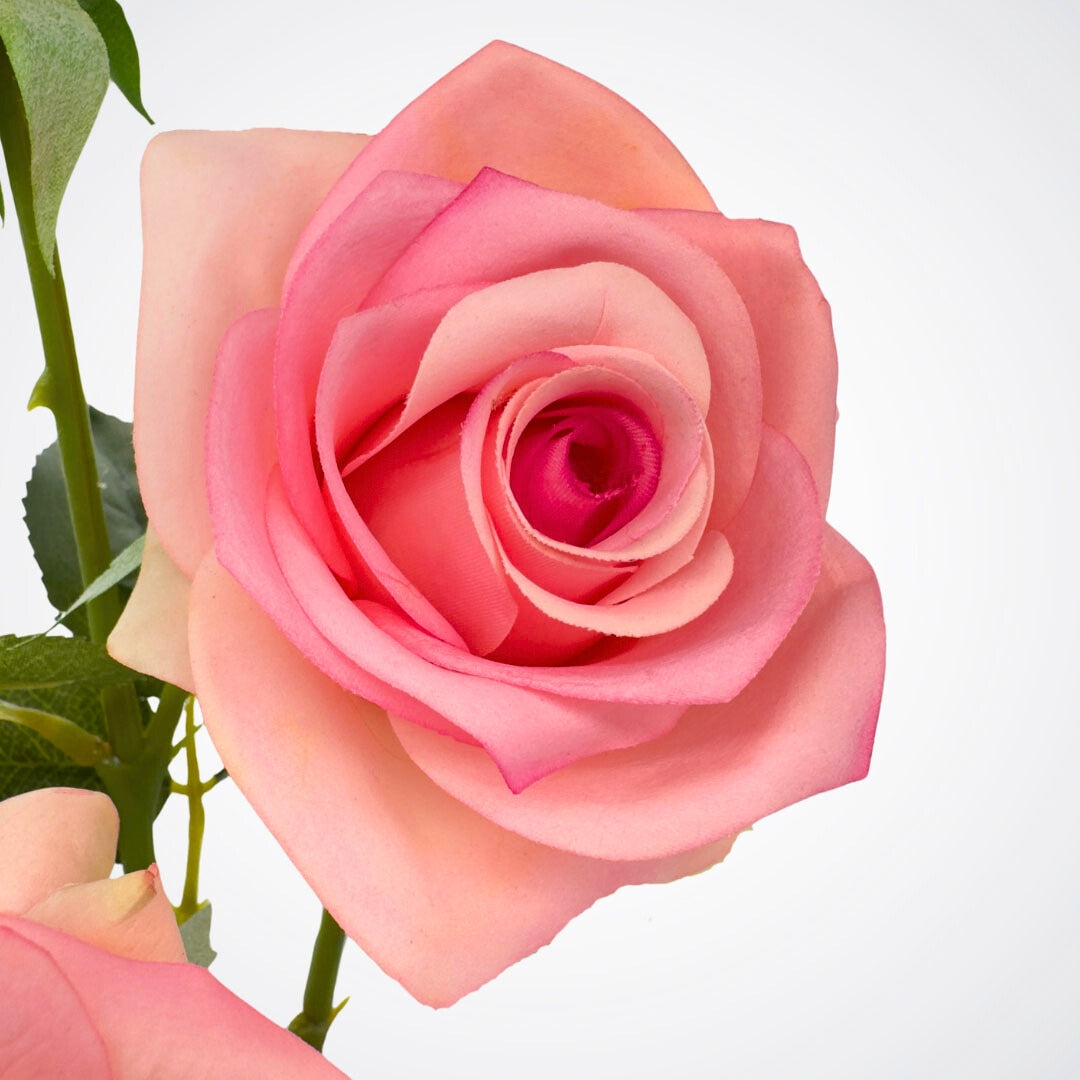 Realistic pink artificial rose detail with petals and green sepals, by Faux Florist Canada