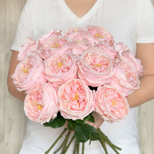 Person holding a bouquet of Austin style artificial roses in a light pink colour with realistic Real Touch petals, from My Faux Florist artificial flowers Canada.