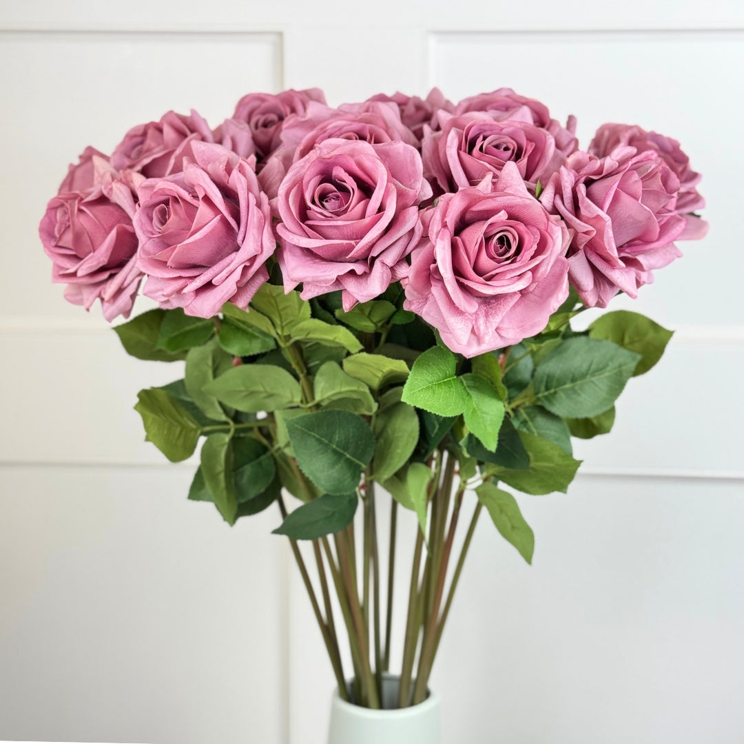 Bouquet of pink roses with green leaves in a white vase against a white background, from My Faux Florist Canada.