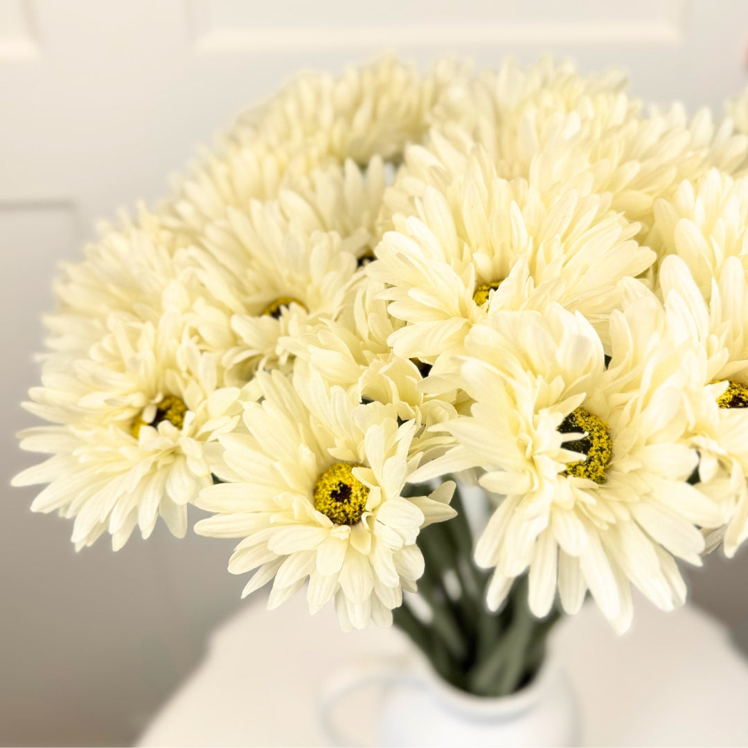 Cluster of artificial white Gerbera Daisies with soft, textured petals