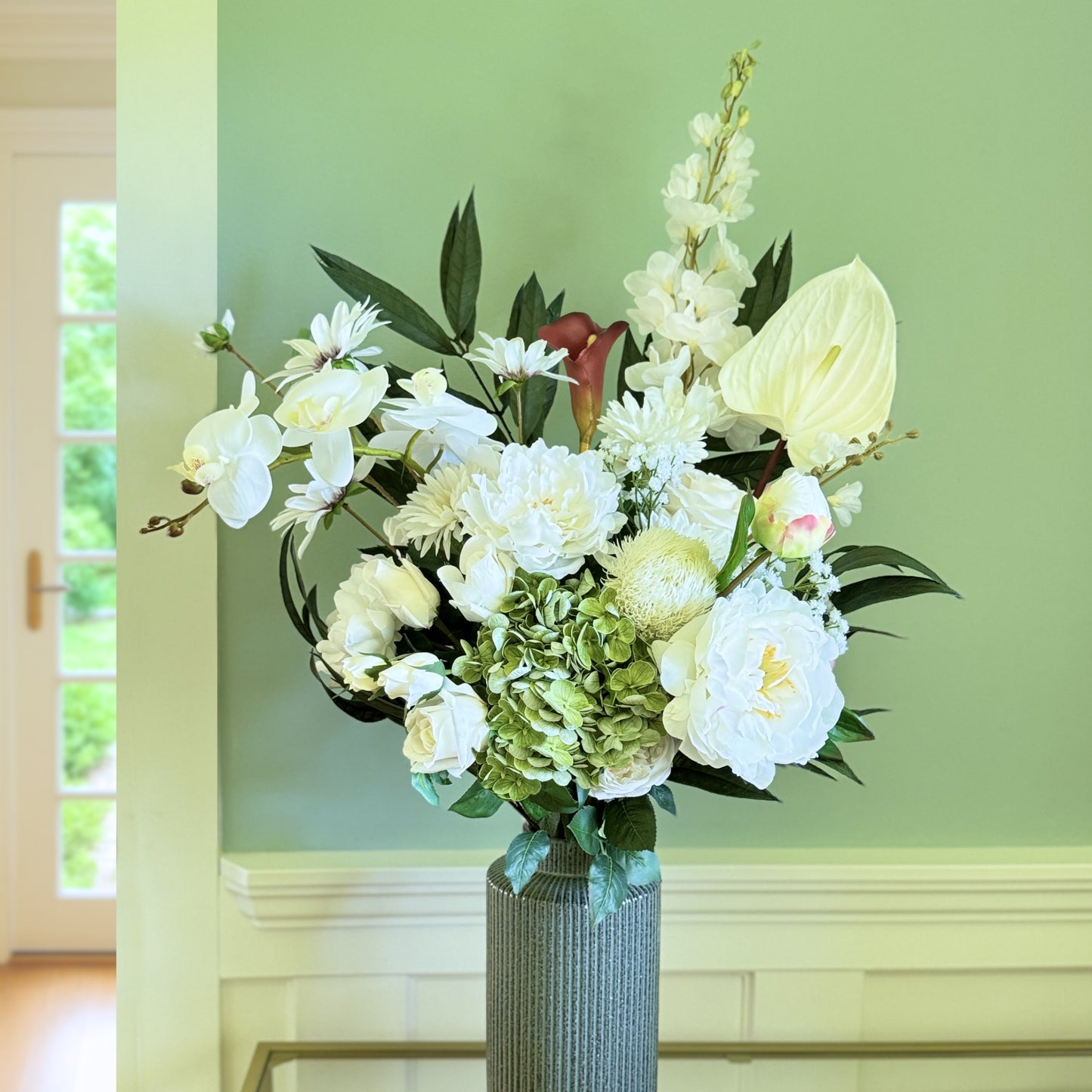 Bouquet of neutral coloured artificial flowers and Real Touch flowers in front of a green wall, by My Faux Florist artificial flowers Canada.