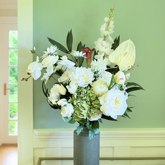 Bouquet of neutral coloured artificial flowers and Real Touch flowers in front of a green wall, by My Faux Florist artificial flowers Canada.