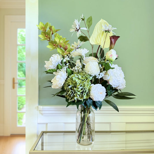 Bouquet of neutral coloured artificial flowers and Real Touch flowers in front of a green wall, by My Faux Florist artificial flowers Canada.
