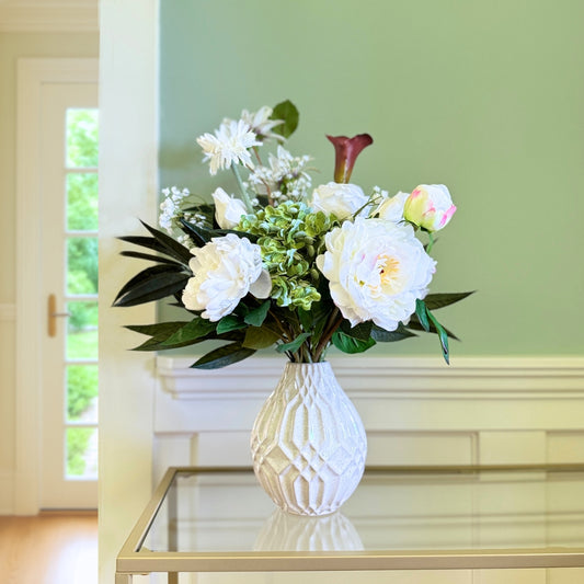 Bouquet of neutral coloured artificial flowers and Real Touch flowers in front of a green wall, by My Faux Florist artificial flowers Canada.