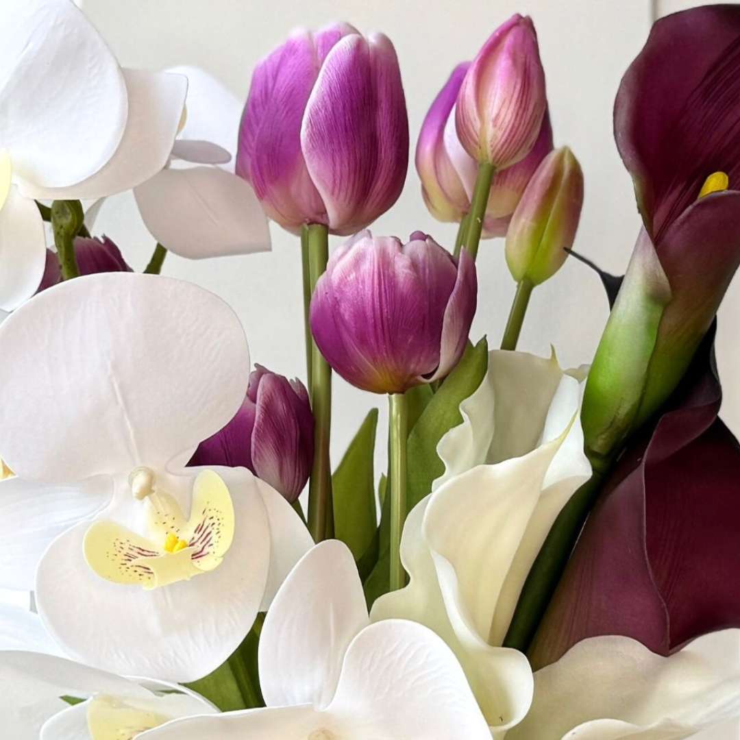 Artificial flower bridal bouquet featuring white artificial orchids, deep wine artificial calla lilies, white artificial calla lilies, and lavender artificial tulips — from My Faux Florist Canada.