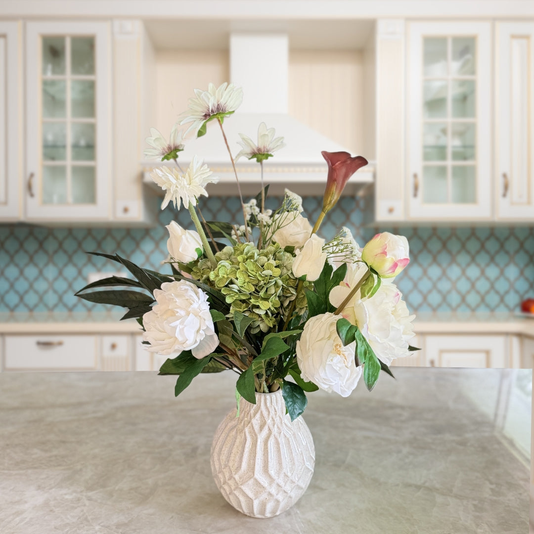 Bouquet of neutral coloured artificial flowers and Real Touch flowers in front of a kitchen, by My Faux Florist artificial flowers Canada.
