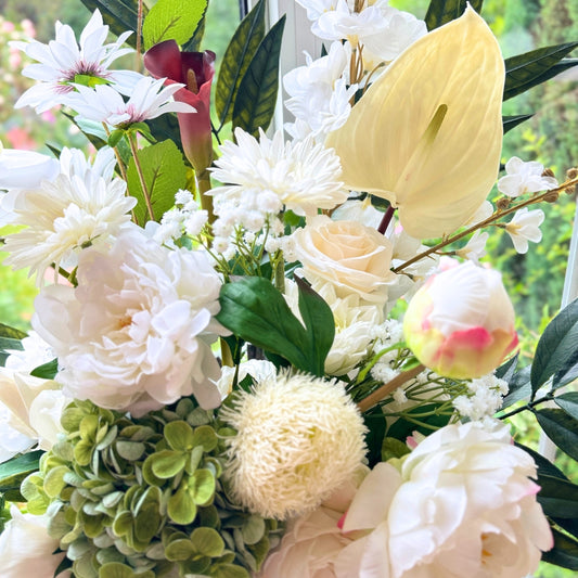 close up of a Bouquet of neutral coloured artificial flowers and Real Touch flowers in a window, by My Faux Florist artificial flowers Canada.