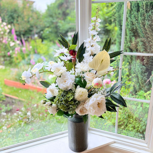 Bouquet of neutral coloured artificial flowers and Real Touch flowers in a window, by My Faux Florist artificial flowers Canada.
