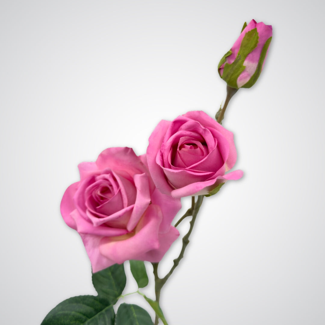Close up of blooms on mauve artificial rose stem featuring two full 'tea rose' blooms and a delicate Real Touch rosebud with deep pink hues and subtle purple undertones by My Faux Florist.