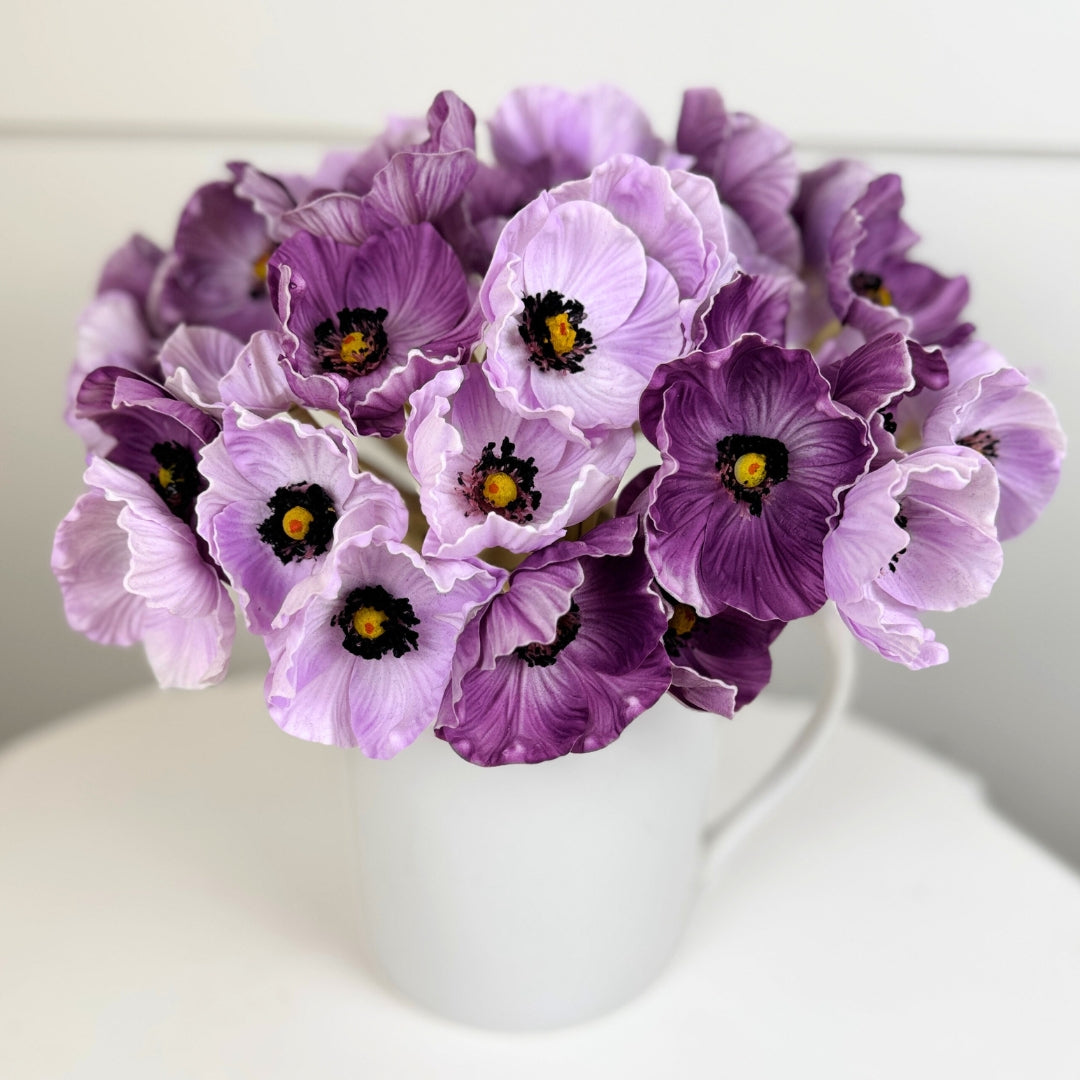 Bouquet of purple artificial poppies in a white vase on a white background from My Faux Florist Canada