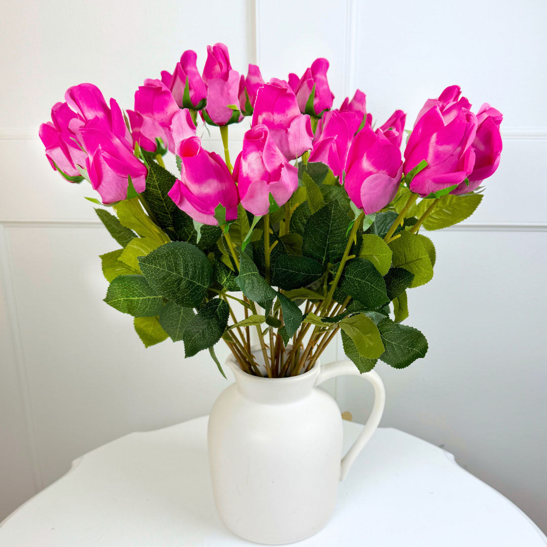 Bouquet vase of fuchsia fake rose flowers in a white vase on a white surface from My Faux Florist Canada