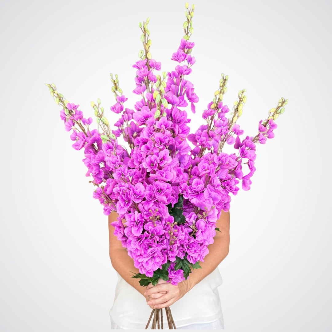 Person holding a huge bunch of fuchsia artificial delphinium flowers with lifelike Real Touch details, by My Faux Florist Canada