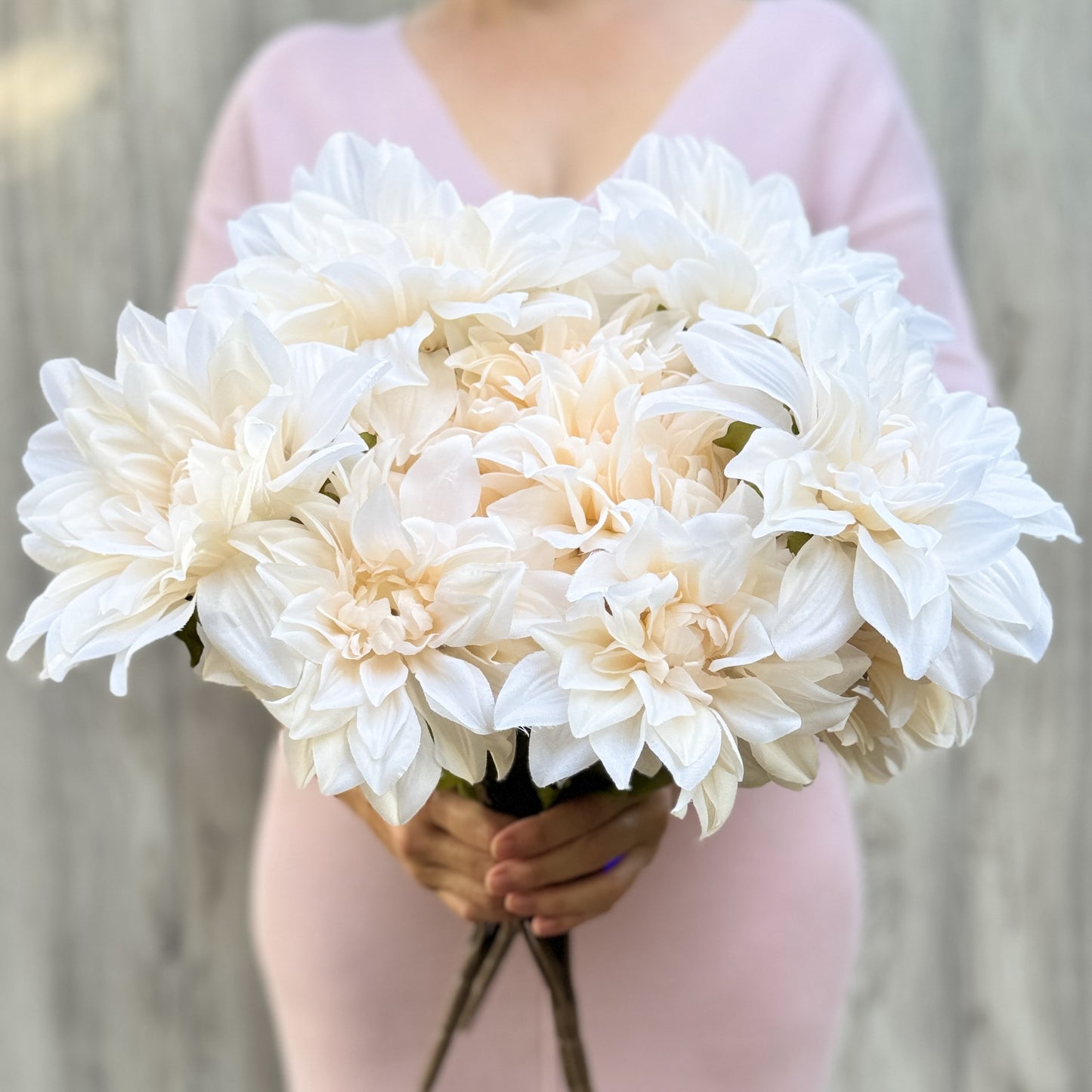 Person holding a large bouquet of  artificial dahlias in a creamy white colour, from My Faux Florist artificial flowers Canada.