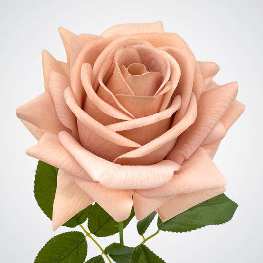 An artificial rose with a Quicksand color, depicting a dusty antique shade, with green leaves from My Faux Florist Canada