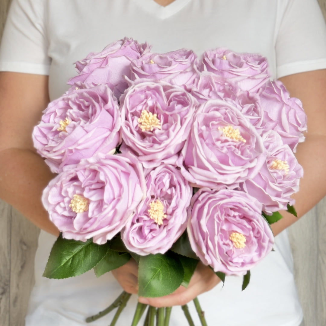 Person holding a bouquet of Austin style artificial roses in a lilac lavender colour with realistic Real Touch petals, from My Faux Florist artificial flowers Canada.
