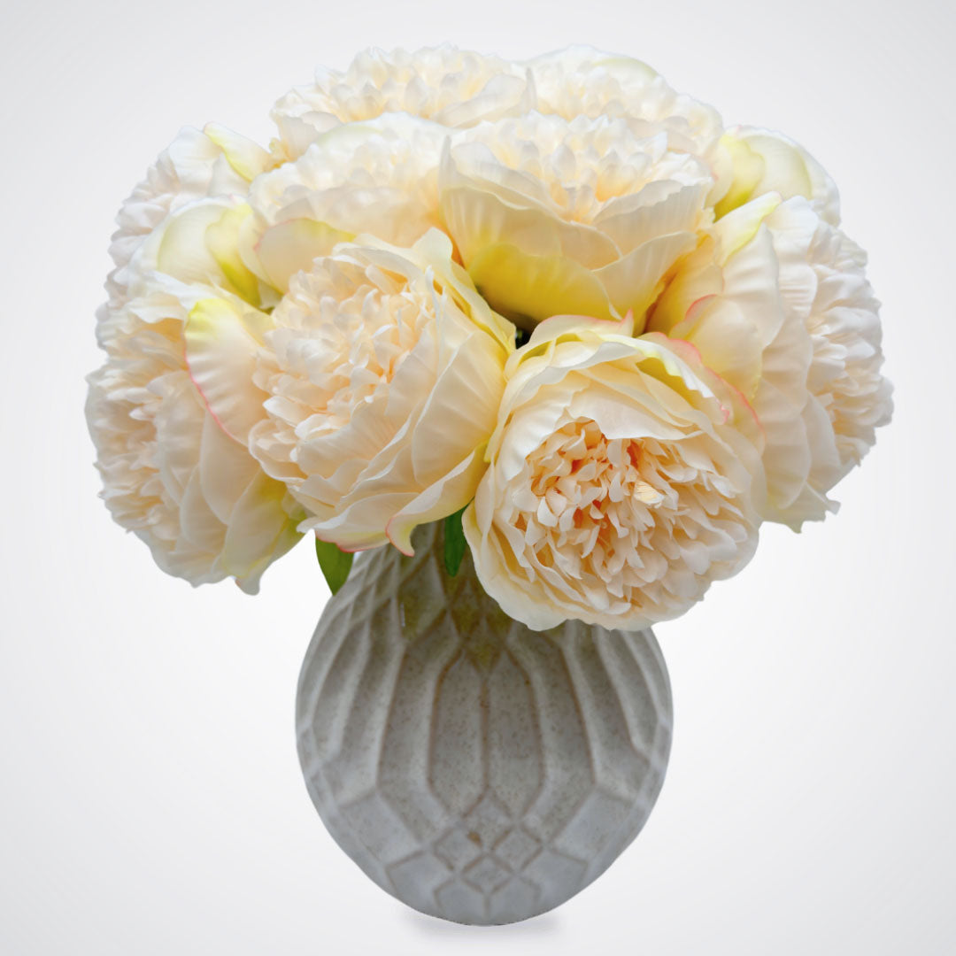 White vase full of white faux peonies in front of a white background, by My Faux Florist artificial flowers Canada.