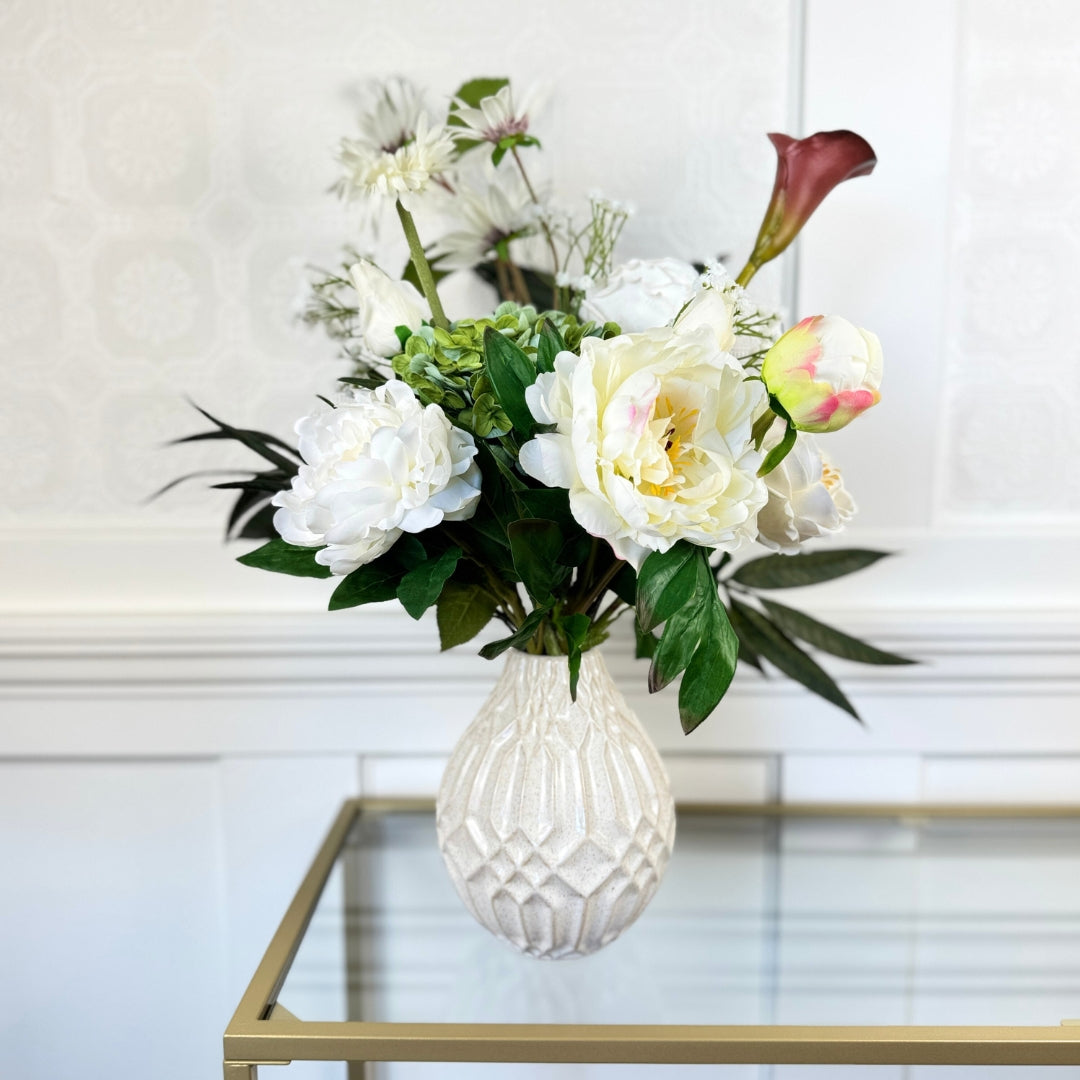 Bouquet of neutral coloured artificial flowers and Real Touch flowers in front of a white wall, by My Faux Florist artificial flowers Canada.