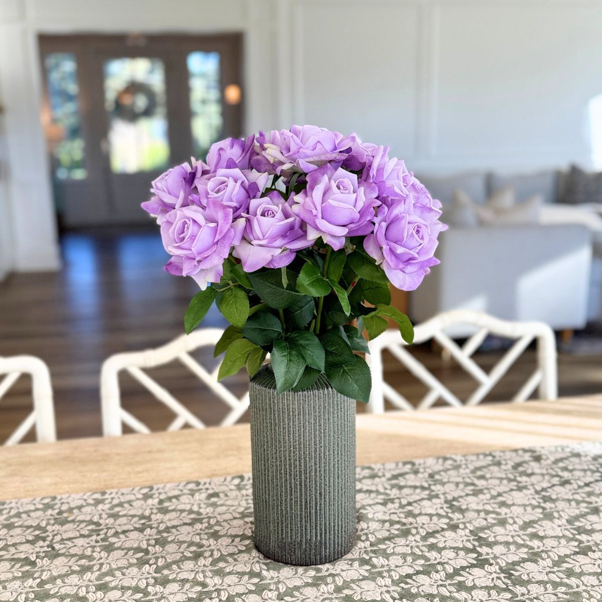 Lilac | Realistic Purple Real Touch artificial roses in a vase in front of a warm white living space | for My Faux Florist Canada