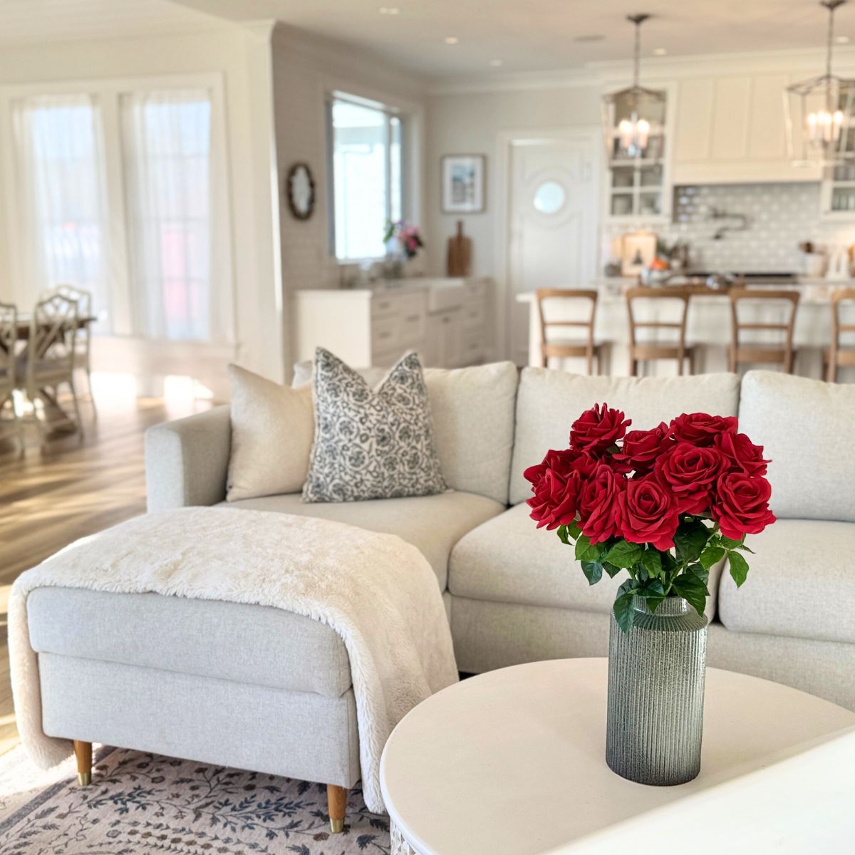 Classic Red | Realistic red Real Touch artificial roses in a vase in front of a warm living room | for My Faux Florist Canada