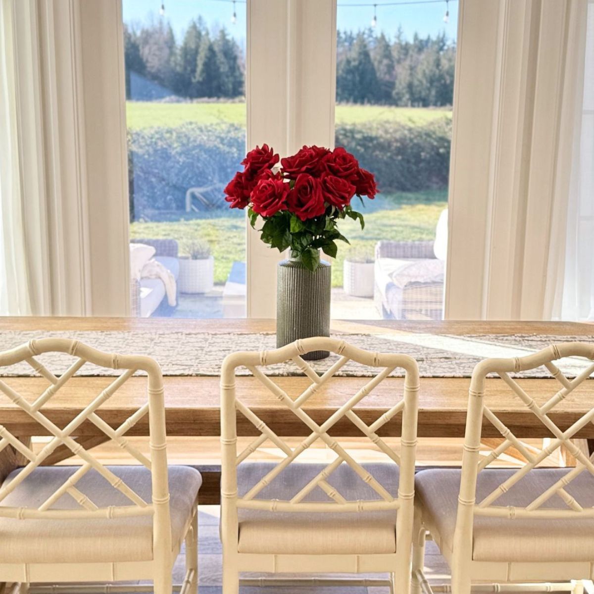 Classic Red | Realistic red Real Touch artificial roses in a vase on a dining table with chairs | for My Faux Florist Canada