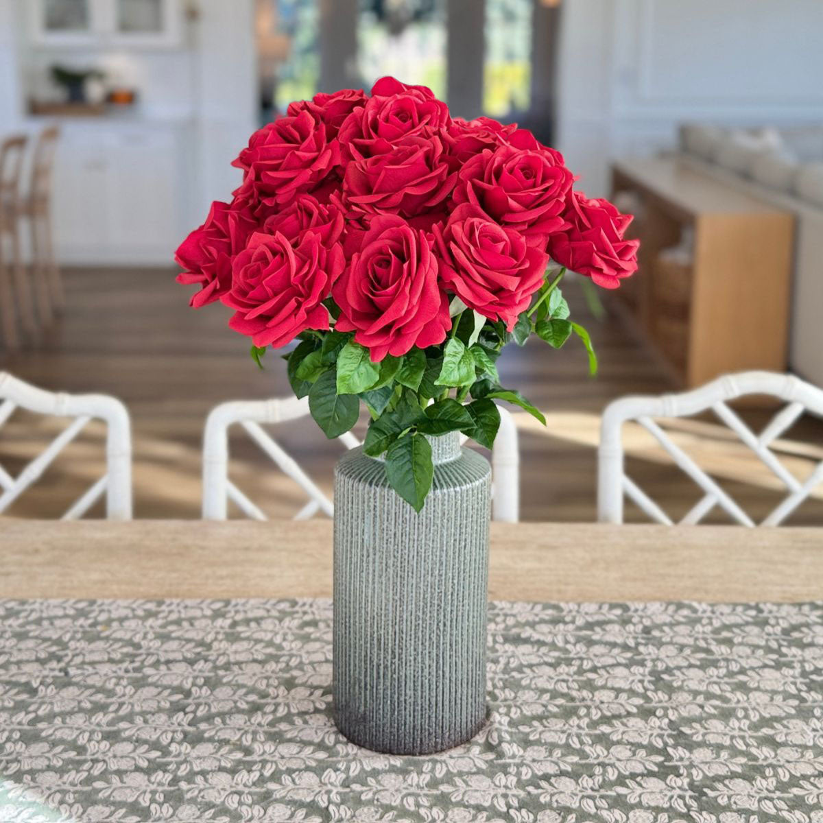 Classic Red | Realistic red Real Touch artificial roses in a vase in front of a warm living space | for My Faux Florist Canada