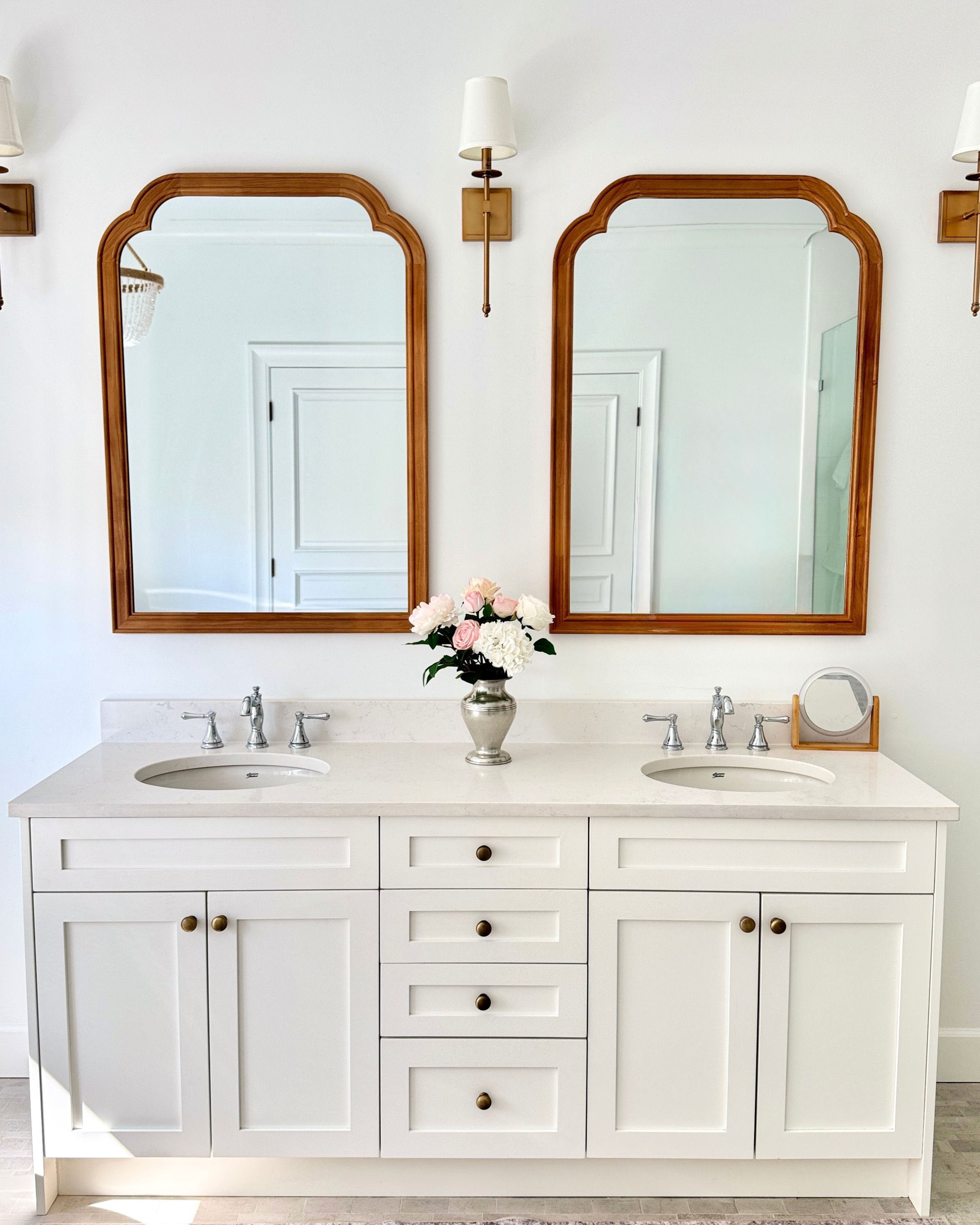 Bathroom vanity with two mirrors, lights, and a vase of realistic artificial flowers. Faux peonies, faux roses, faux hydrangea,  in an artificial flower bouquet for My Faux Florist Canada.