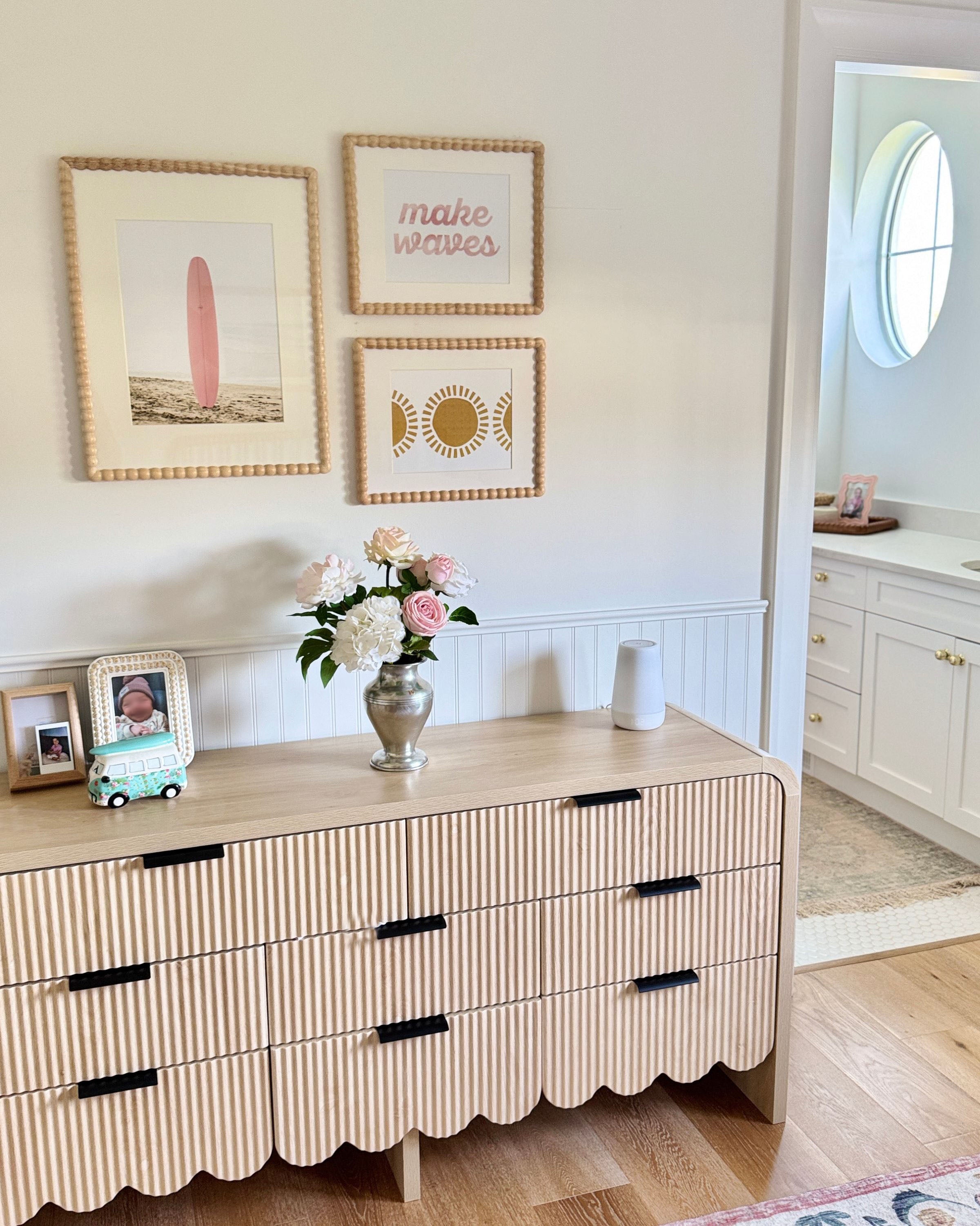 Beige dresser with black handles in a room with framed artwork on the wall, and a bouquet of realistic artificial flowers on the dresser. Faux peonies, faux roses, faux hydrangea in an artificial flower bouquet for My Faux Florist Canada.