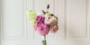Turntable of a realistic artificial flower bridal bouquet featuring antique cream artificial roses, dusty mauve artificial roses, blush artificial peonies, pink artificial dahlias, pale green artificial hydrangeas, green artificial peonies, and deep wine artificial calla lilies — from My Faux Florist Canada.