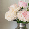 Video of silver vase containing realistic artificial flowers sits on a fireplace mantel.  The vase includes artificial roses, artificial peonies and artificial hydrangea in shades of pink, white and cream.  For My Faux Florist Canada.