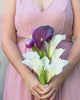 Bridesmaid holding a realistic artificial flower bouquet featuring deep plum artificial calla lilies, white artificial calla lilies, and purple artificial tulips — a modern and elegant design from My Faux Florist Canada.