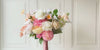 Turntable showcasing  a realistic artificial flower bridal bouquet featuring white artificial roses, blush artificial peonies, apricot artificial tulips, cream artificial tea roses, pink artificial hydrangeas, and white artificial cosmos — from My Faux Florist Canada.
