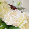 Turntable showcasing a realistic artificial flower bridal bouquet featuring pale green artificial hydrangeas, white artificial dahlias, white artificial peonies, white artificial tea roses, white artificial Austin roses, and deep wine artificial calla lilies accented with soft lamb’s ear greenery — from My Faux Florist Canada.