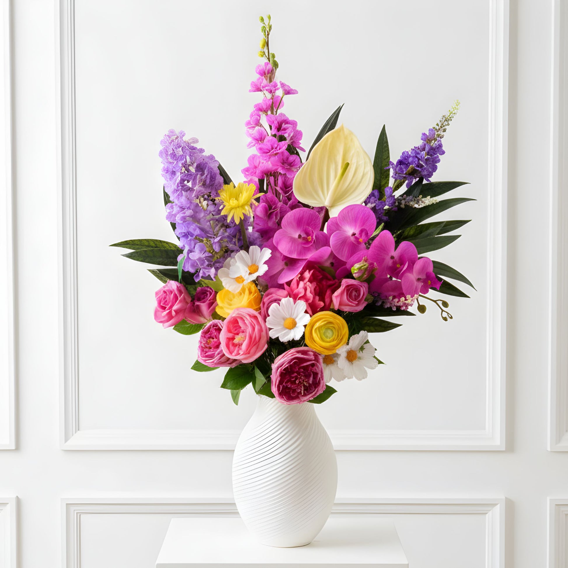 Colorful bouquet of realistic artificial flowers in a white vase against a white paneled wall - for My Faux Florist Canada