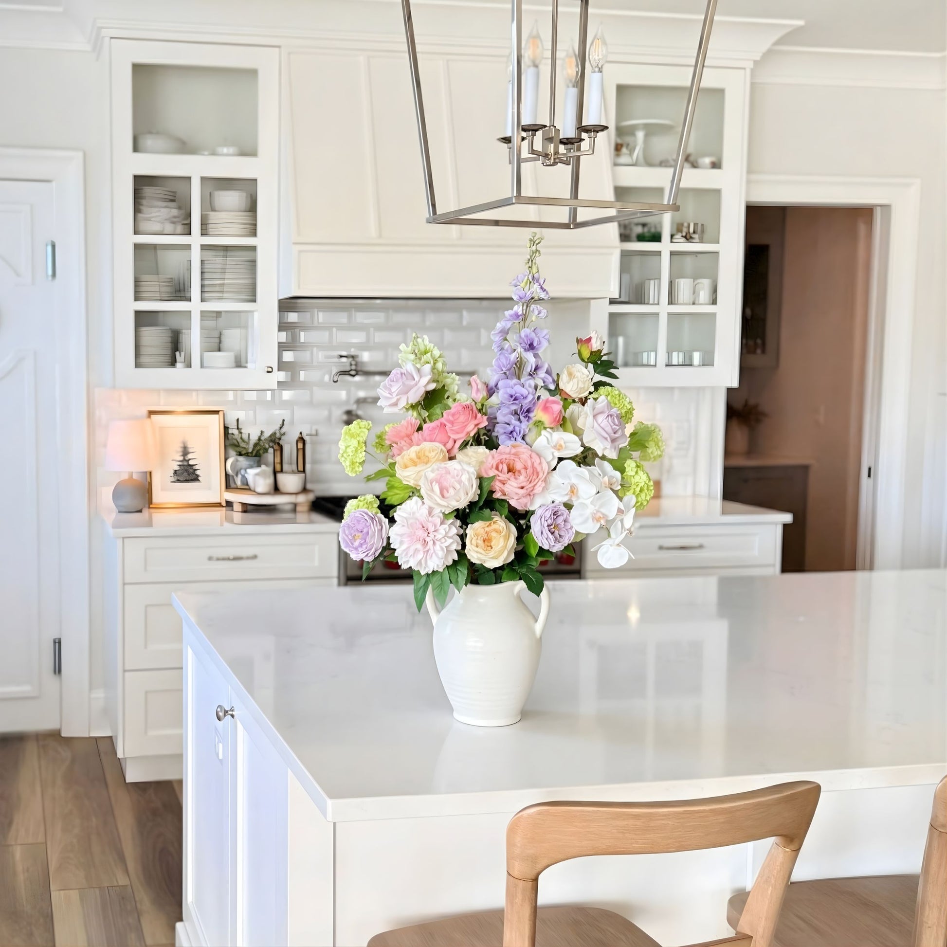 Kitchen with a vase of realistic artificial flowers in antique colours on the counter. Faux peonies, faux roses, faux hydrangea, and faux orchids in an artificial flower bouquet for My Faux Florist Canada.