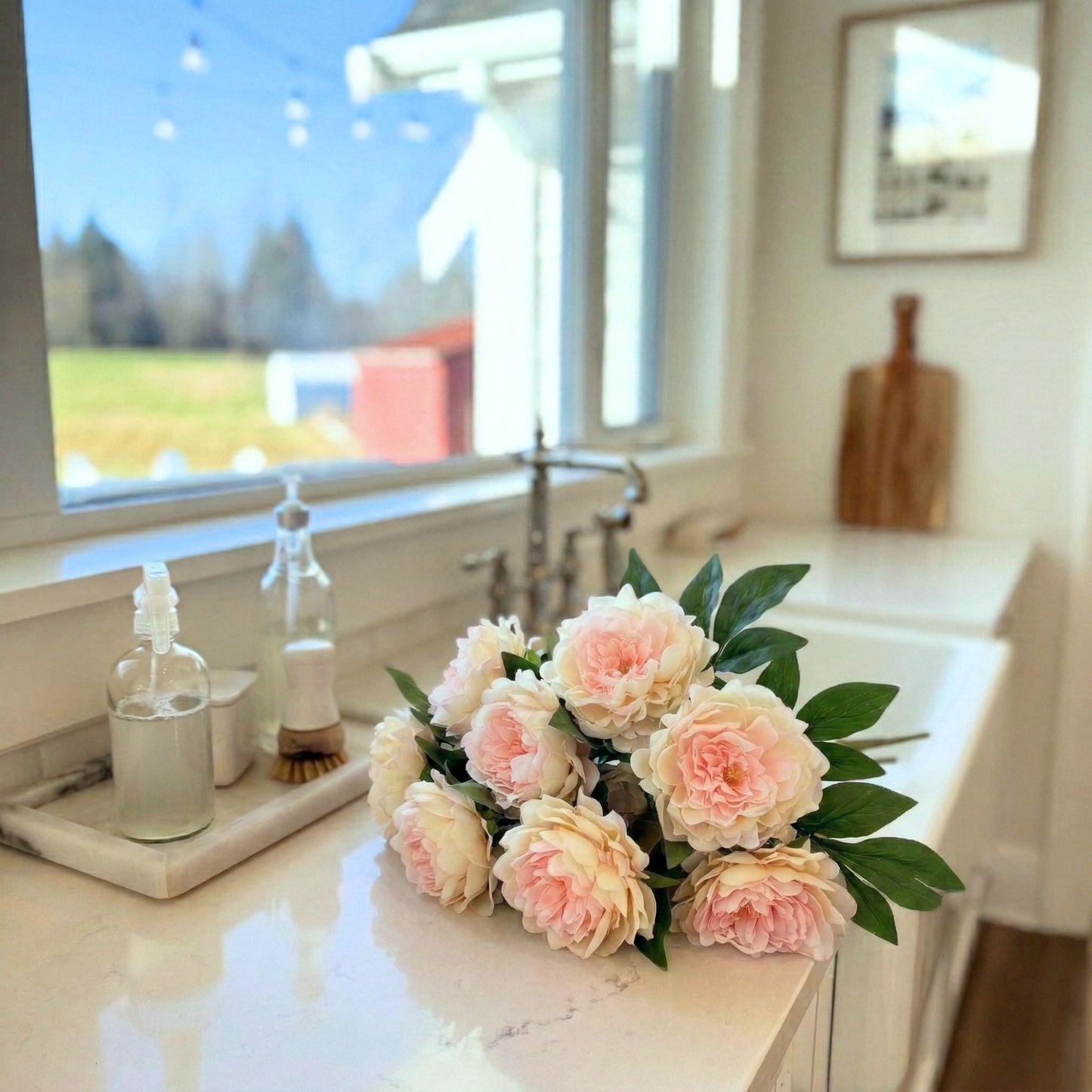 Bouquet of pink realistic artificial peonies on a kitchen counter with a window in the background, for My Faux Florist Canada
