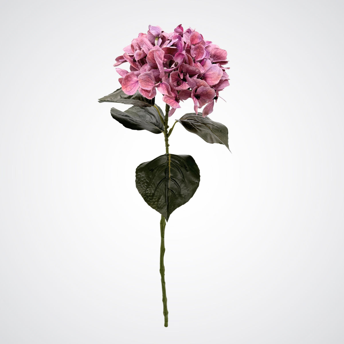 A single realistic artificial pink hydrangea stem with dark green leaves, isolated on a light gray background. From My Faux Florist Canada.