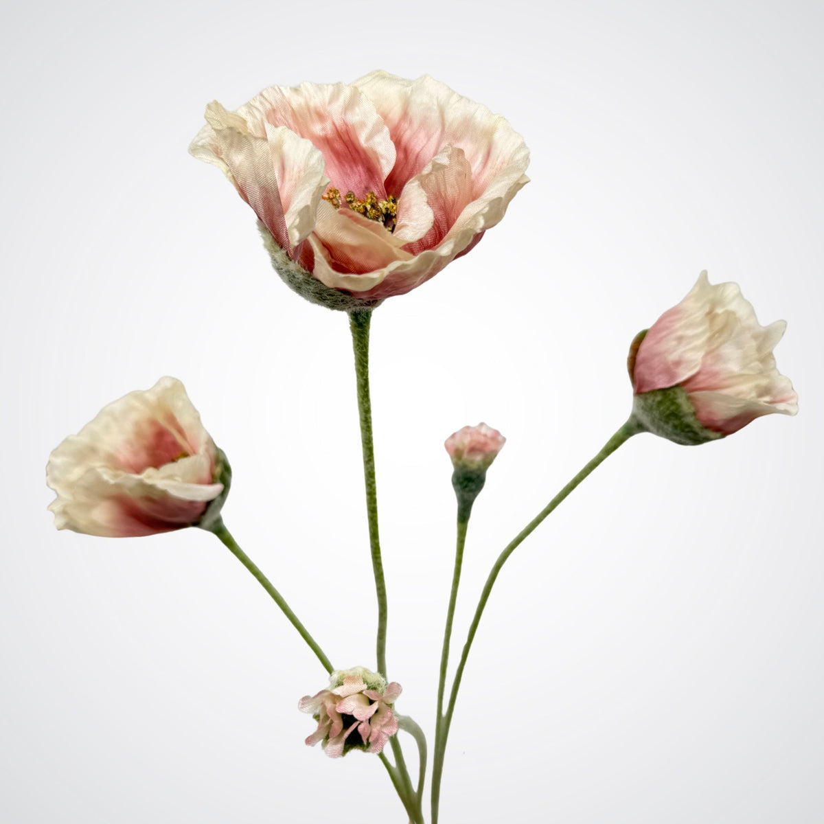 Three artificial silk poppy flowers with pale pink and cream petals on long green stems, arranged against a plain light gray background. For My Faux Florist Canada.