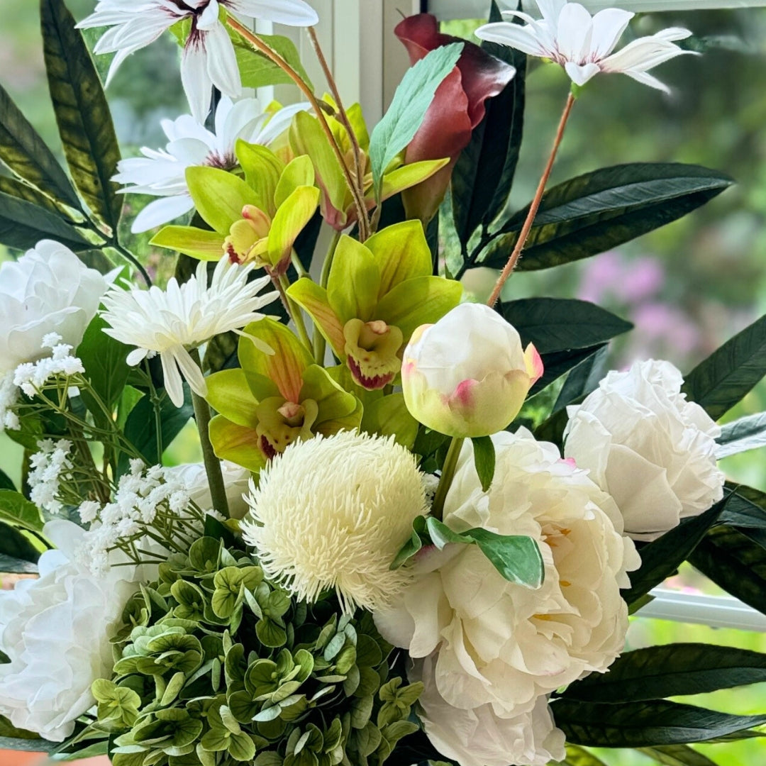 Close up of a Bouquet of neutral coloured artificial flowers and Real Touch flowers in front of a window, by My Faux Florist artificial flowers Canada.