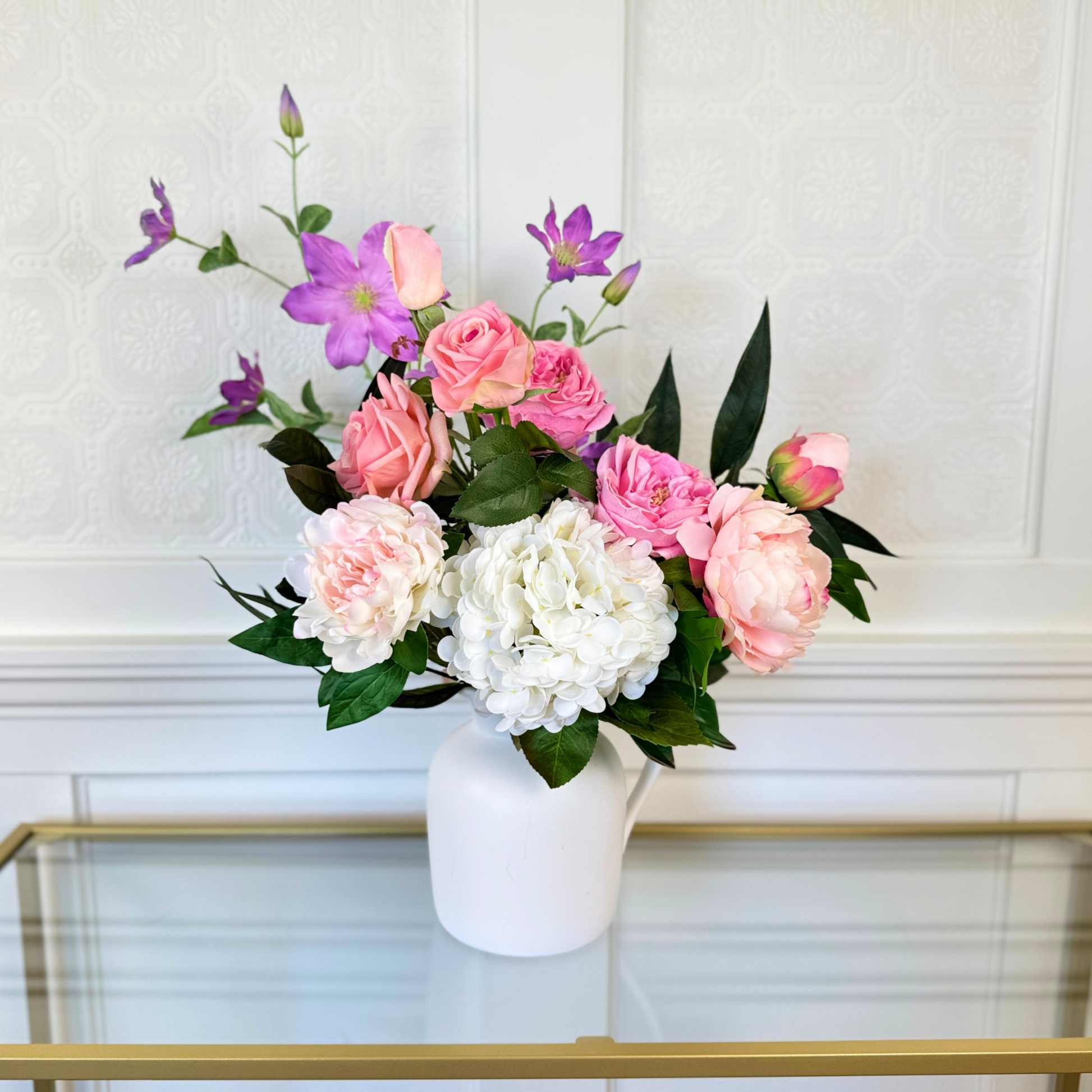 Bouquet of brightly coloured artificial flowers and Real Touch flowers in front of a white wall, by My Faux Florist artificial flowers Canada.