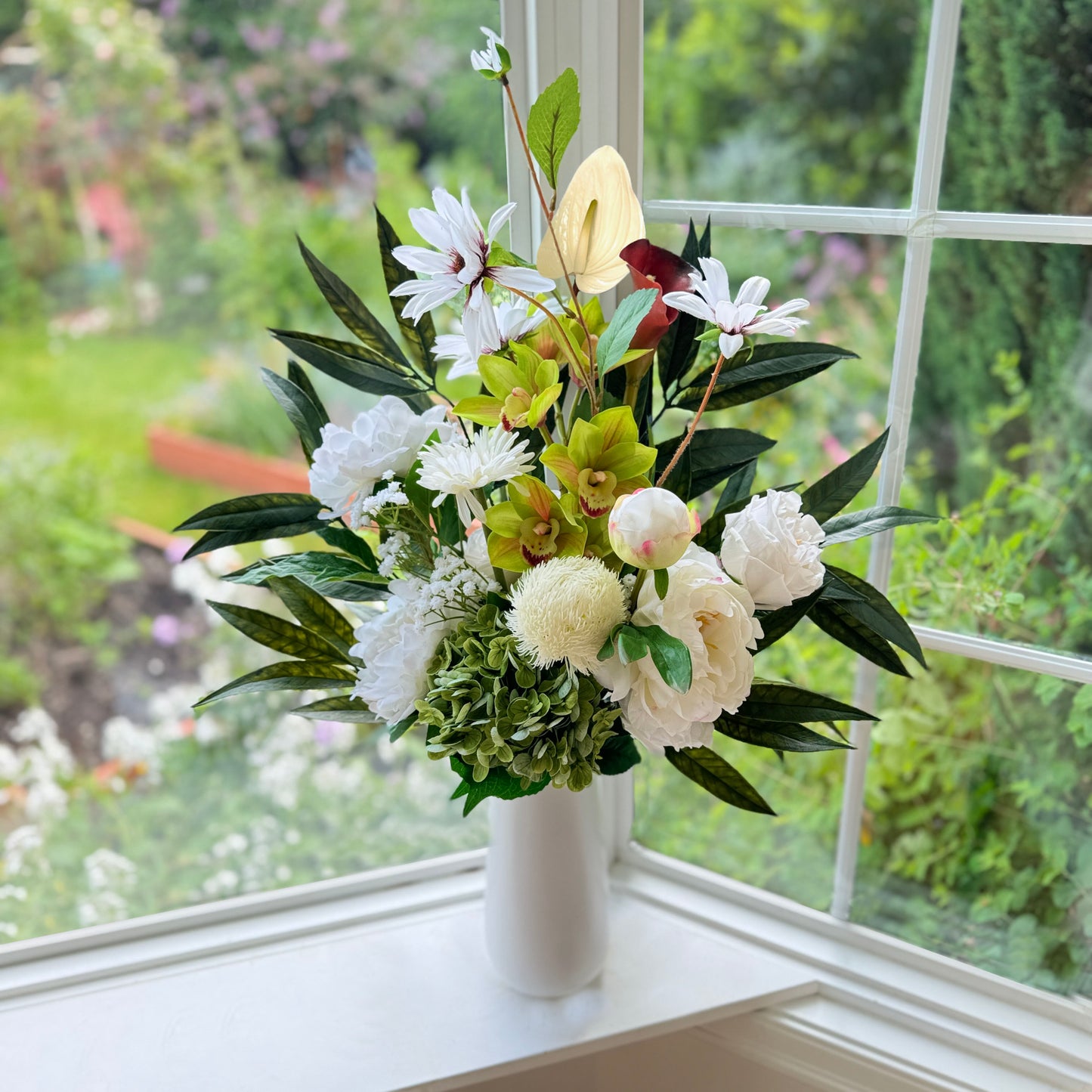 Bouquet of neutral coloured artificial flowers and Real Touch flowers in front of a window, by My Faux Florist artificial flowers Canada.