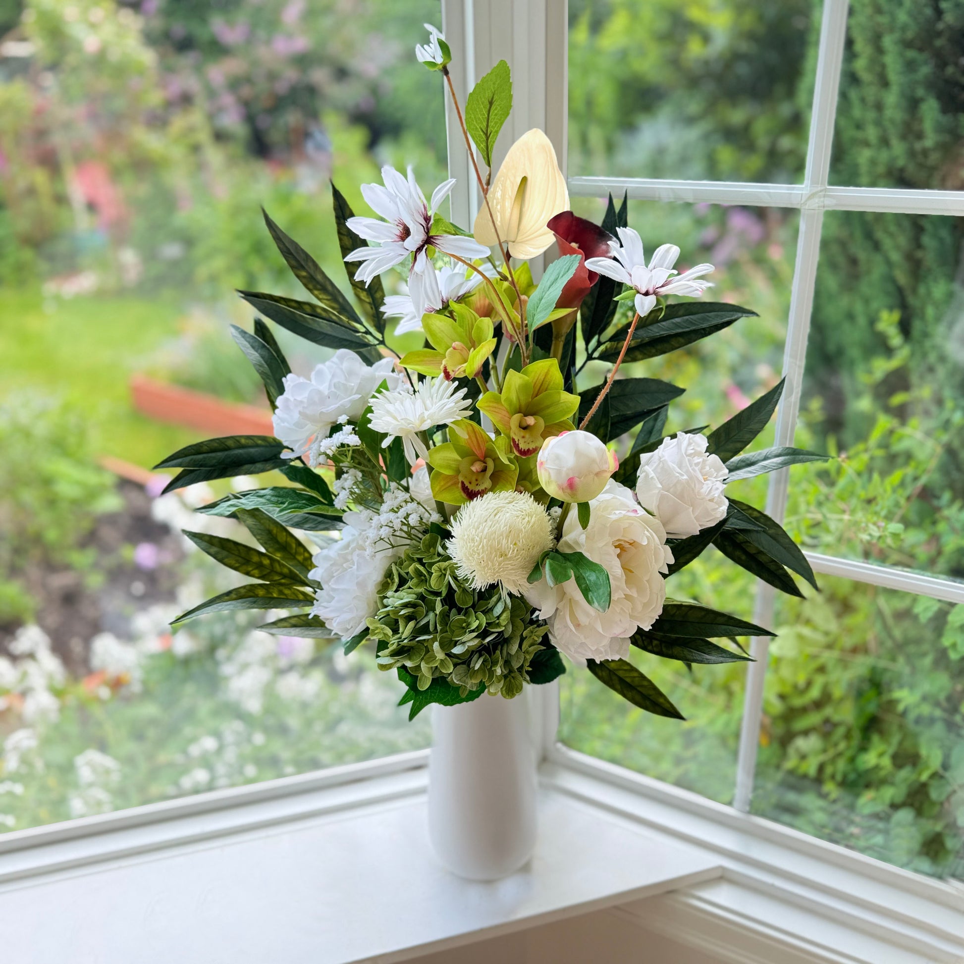 Bouquet of neutral coloured artificial flowers and Real Touch flowers in front of a window, by My Faux Florist artificial flowers Canada.